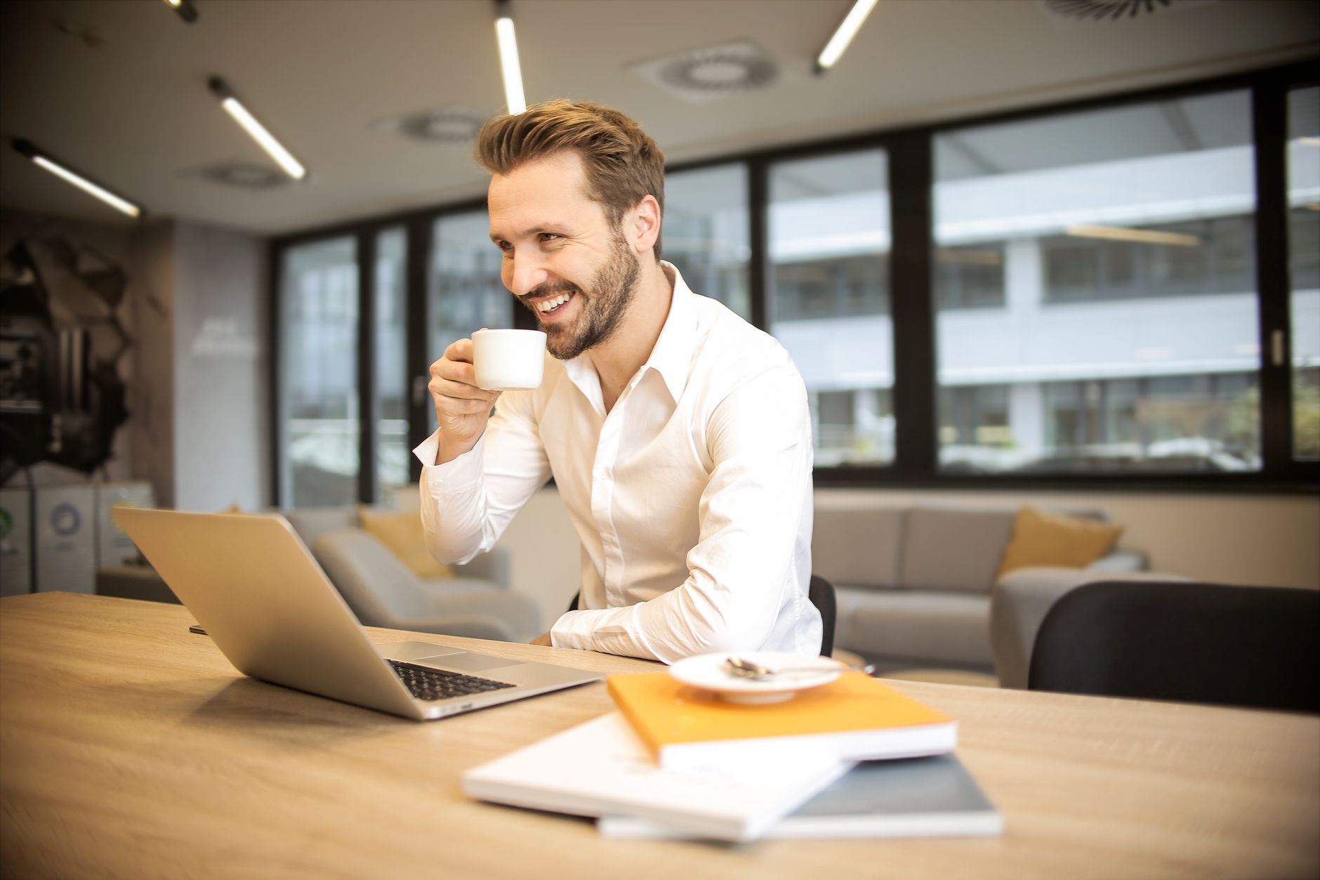 Working at a laptop with documents